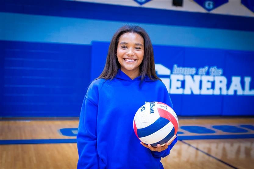 Students play volleyball in PE